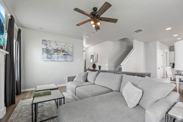 7886 N Bridleway Rd, Eagle Mountain, UT 84005 - living room with ceiling fan, light wood-style floors, recessed lighting, baseboards, and stairway