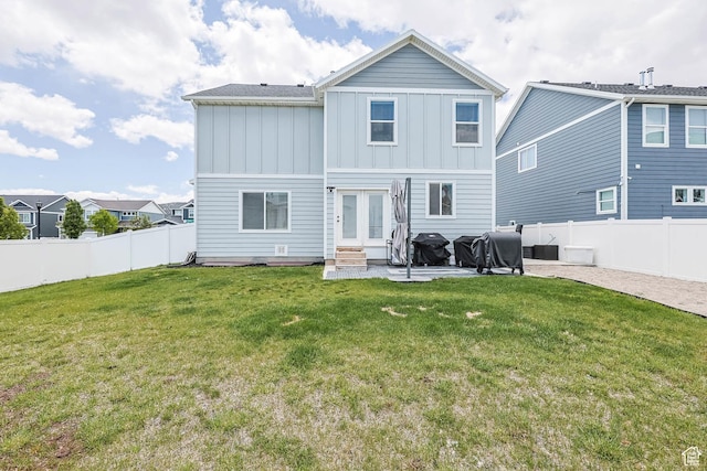 7886 N Bridleway Rd, Eagle Mountain, UT 84005 - back of house featuring board and batten siding, entry steps, a patio area, and french doors