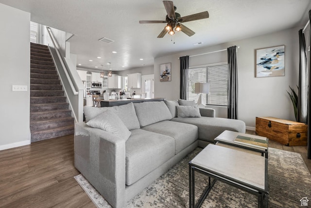 7886 N Bridleway Rd, Eagle Mountain, UT 84005 - living area featuring stairs, ceiling fan, healthy amount of natural light, dark wood finished floors, and recessed lighting