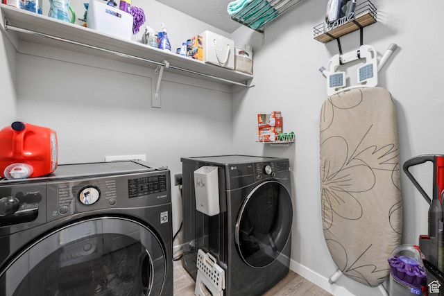 7886 N Bridleway Rd, Eagle Mountain, UT 84005 - laundry room with washing machine and dryer, wood finished floors, and baseboards