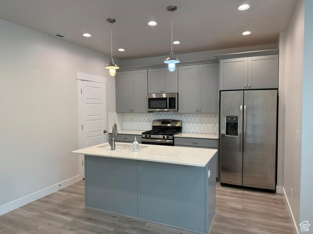 6396 W Sugarcane Dr W Unit 345, South Jordan, UT 84009 - kitchen featuring appliances with stainless steel finishes, a sink, gray cabinets, light wood-type flooring, and recessed lighting