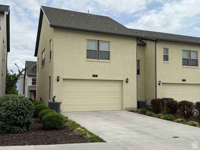 6396 W Sugarcane Dr W Unit 345, South Jordan, UT 84009 - view of front of property with stucco siding, an attached garage, driveway, and roof with shingles