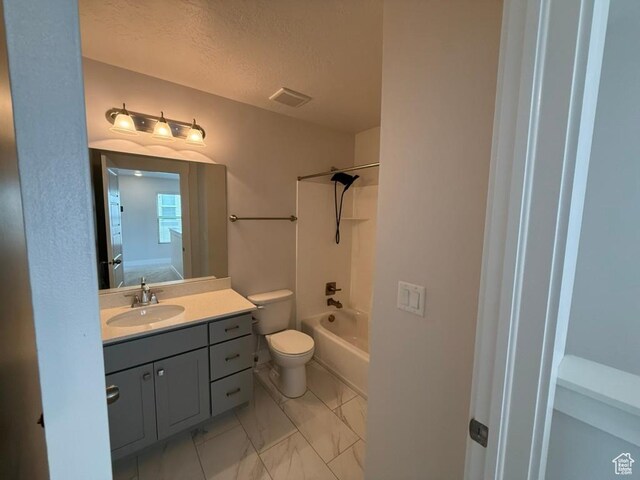6396 W Sugarcane Dr W Unit 345, South Jordan, UT 84009 - full bath featuring marble look tiles, toilet, vanity, shower / bathtub combination, and a textured ceiling