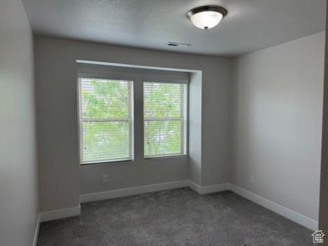6396 W Sugarcane Dr W Unit 345, South Jordan, UT 84009 - carpeted empty room featuring baseboards