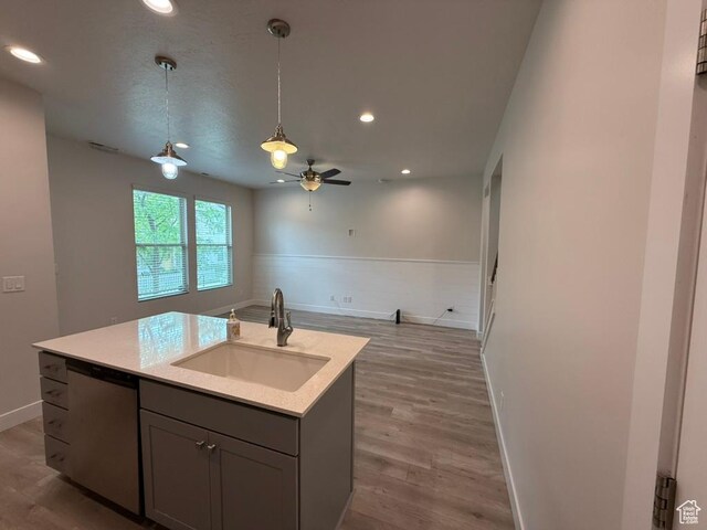 6396 W Sugarcane Dr W Unit 345, South Jordan, UT 84009 - kitchen featuring a sink, stainless steel dishwasher, open floor plan, light countertops, and baseboards