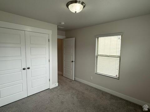 6396 W Sugarcane Dr W Unit 345, South Jordan, UT 84009 - unfurnished bedroom featuring a closet, carpet flooring, and baseboards