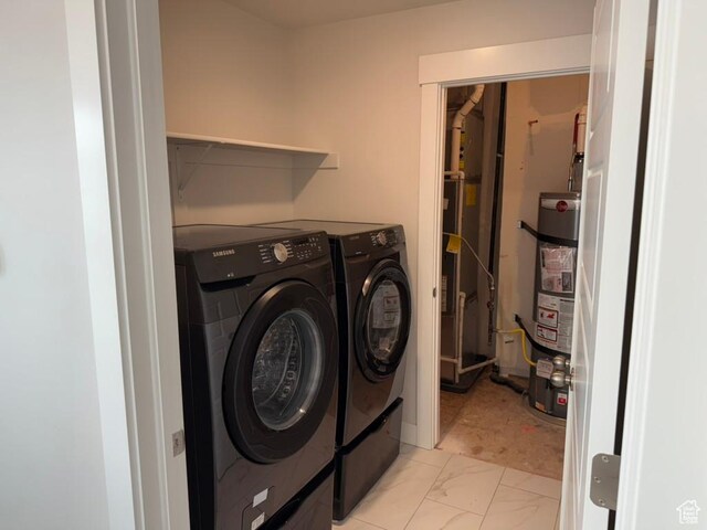 6396 W Sugarcane Dr W Unit 345, South Jordan, UT 84009 - laundry room featuring washer and dryer, strapped water heater, and light marble finish floors