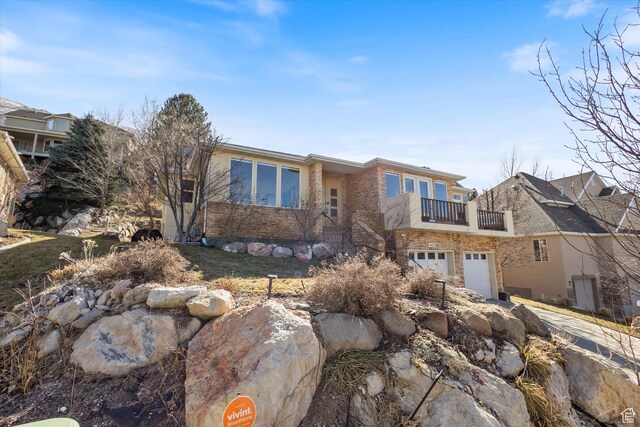 442 E Brew Rd, Draper, UT 84020 - view of front facade featuring a balcony, an attached garage, concrete driveway, and brick siding
