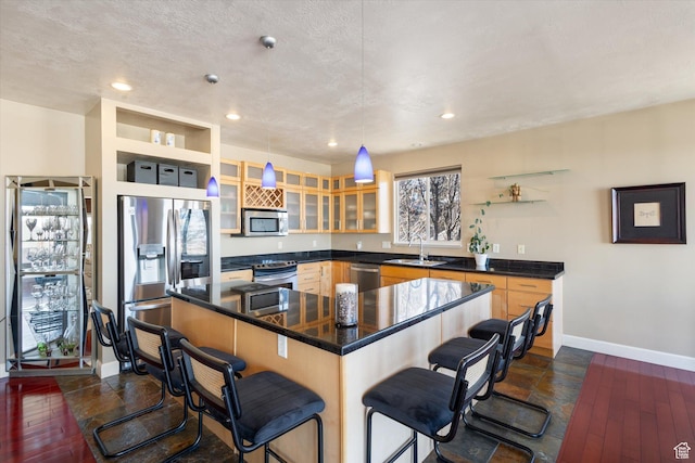 442 E Brew Rd, Draper, UT 84020 - kitchen featuring appliances with stainless steel finishes, a sink, baseboards, a breakfast bar area, and glass insert cabinets
