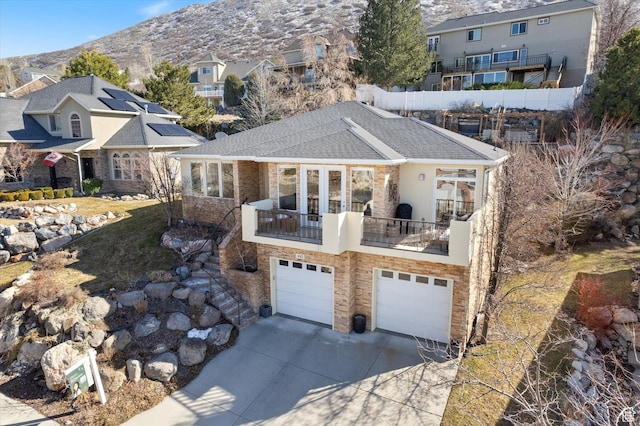 442 E Brew Rd, Draper, UT 84020 - back of property featuring concrete driveway, an attached garage, a mountain view, a balcony, and a shingled roof