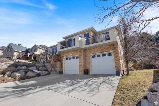 442 E Brew Rd, Draper, UT 84020 - view of front of home with concrete driveway, a balcony, an attached garage, stairs, and brick siding