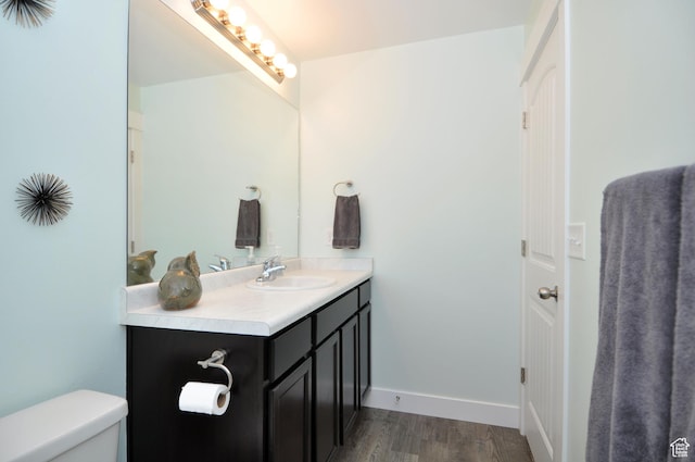 5213 W Courtly Ln, Herriman, UT 84096 - bathroom featuring vanity, wood finished floors, toilet, and baseboards