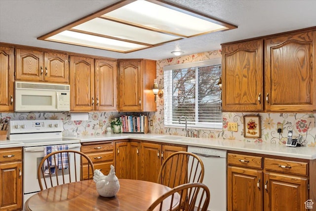 1154 N 700 W, Centerville, UT 84014 - kitchen featuring white appliances, a sink, and brown cabinetry