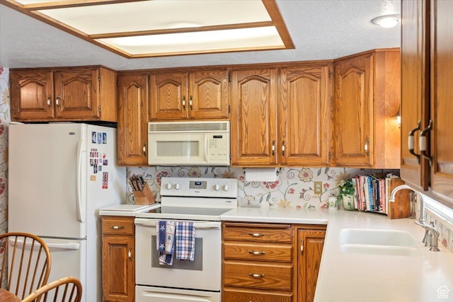 1154 N 700 W, Centerville, UT 84014 - kitchen with white appliances, brown cabinetry, a sink, light countertops, and a textured ceiling