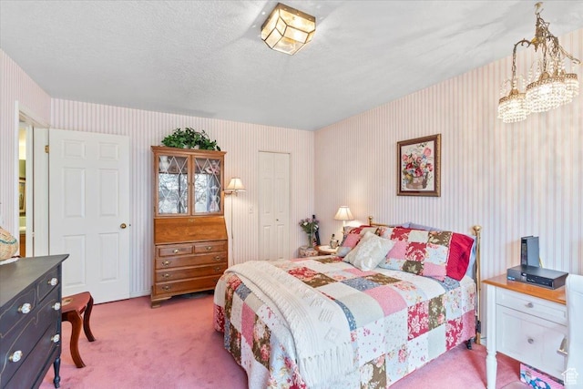 1154 N 700 W, Centerville, UT 84014 - carpeted bedroom featuring wallpapered walls, a closet, a chandelier, and a textured ceiling