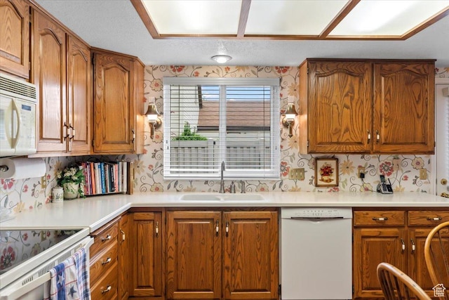 1154 N 700 W, Centerville, UT 84014 - kitchen with white appliances, a sink, wallpapered walls, and brown cabinets