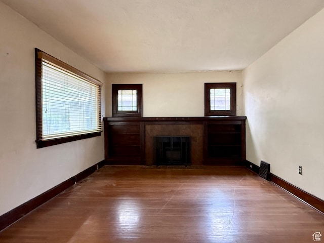 1980 S 600 E, Salt Lake City, UT 84105 - unfurnished living room with a glass covered fireplace, baseboards, and wood finished floors