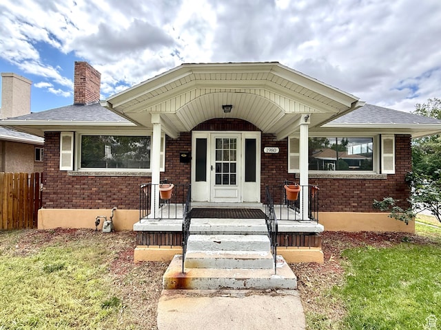 1980 S 600 E, Salt Lake City, UT 84105 - doorway to property featuring brick siding, a chimney, a shingled roof, and covered porch