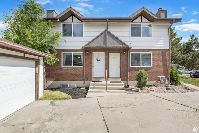 8316 S Carmen Ct E, Sandy, UT 84070 - multi unit property featuring brick siding, a chimney, driveway, and an attached garage
