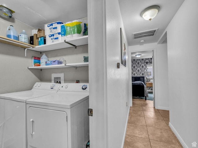 7409 S Main St W, Midvale, UT 84047 - laundry area featuring washing machine and clothes dryer, light tile patterned flooring, and baseboards