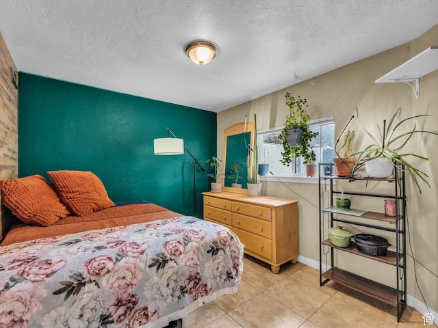 7409 S Main St W, Midvale, UT 84047 - bedroom featuring an accent wall, a textured ceiling, light tile patterned floors, and baseboards