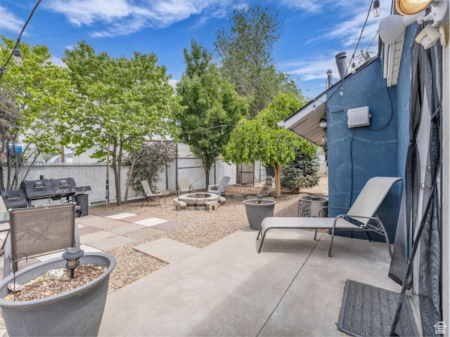 7409 S Main St W, Midvale, UT 84047 - fenced backyard with a fire pit, a patio, grilling area, and cooling unit