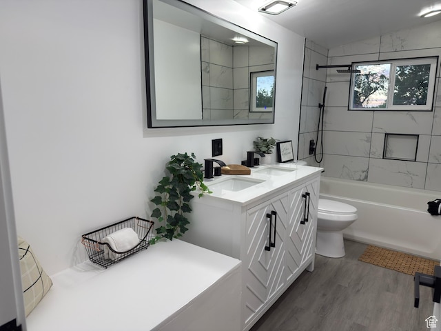 4868 W Seneca Rd S, West Valley City, UT 84120 - full bathroom featuring washtub / shower combination, wood finished floors, toilet, and double vanity