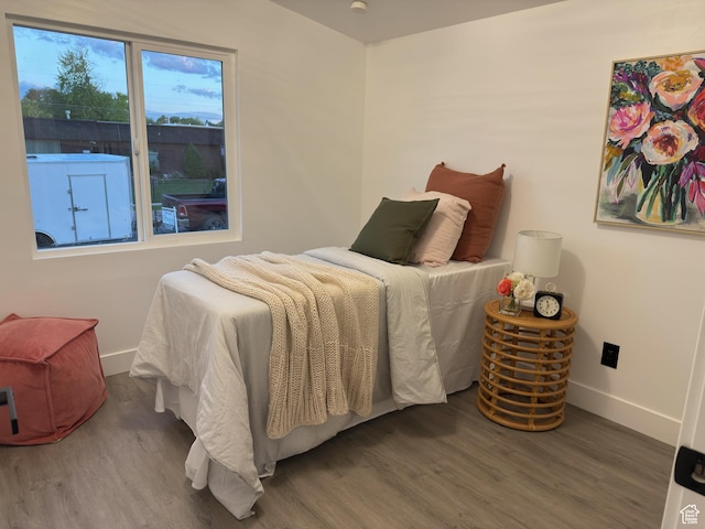4868 W Seneca Rd S, West Valley City, UT 84120 - bedroom featuring wood finished floors and baseboards