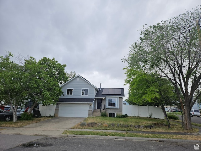 417 W 225 N, Clearfield, UT 84015 - view of front of house featuring solar panels, driveway, an attached garage, and cooling unit