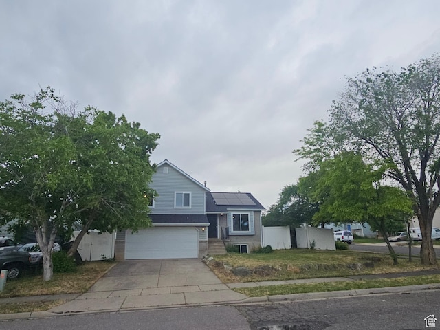 417 W 225 N, Clearfield, UT 84015 - view of front of house with roof mounted solar panels, concrete driveway, and an attached garage