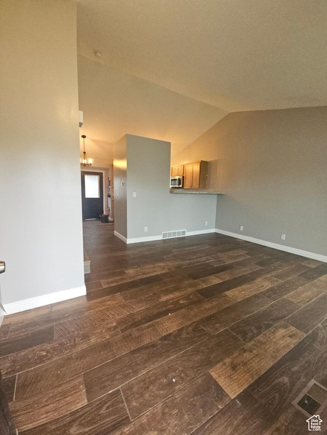 417 W 225 N, Clearfield, UT 84015 - unfurnished living room featuring dark wood finished floors, vaulted ceiling, and baseboards