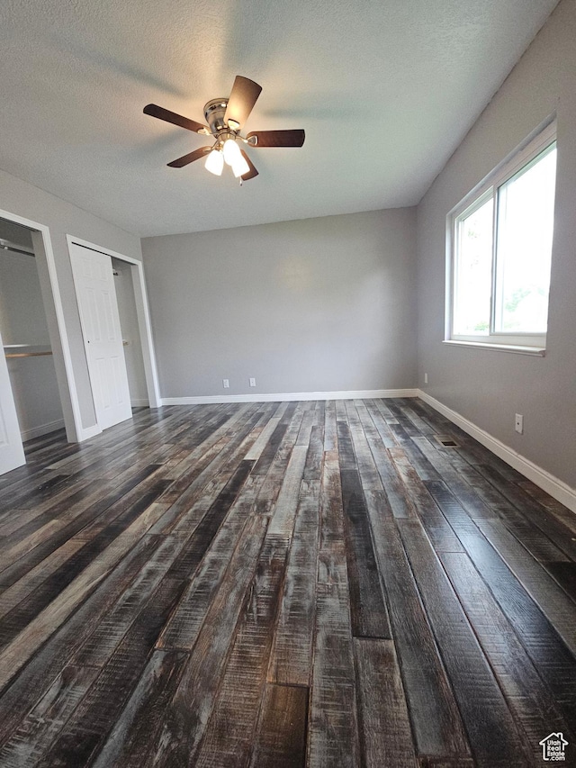 417 W 225 N, Clearfield, UT 84015 - unfurnished bedroom with wood finished floors, a ceiling fan, two closets, baseboards, and a textured ceiling