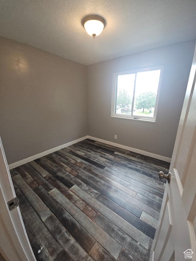 417 W 225 N, Clearfield, UT 84015 - unfurnished room with dark wood-type flooring, a textured ceiling, and baseboards
