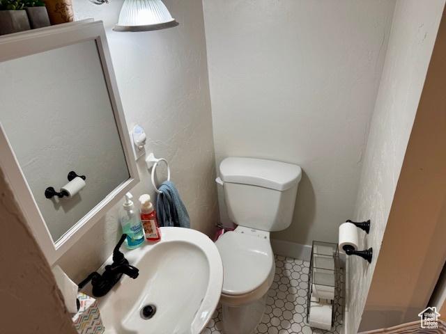64 S 300 E, Preston, ID 83263 - half bathroom with a sink, toilet, and tile patterned floors