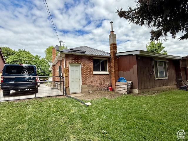 64 S 300 E, Preston, ID 83263 - rear view of property featuring a chimney and brick siding