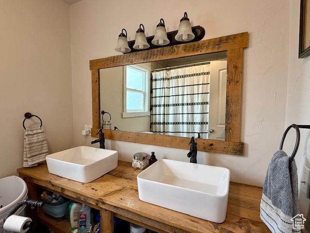 64 S 300 E, Preston, ID 83263 - bathroom featuring a sink and a shower with shower curtain