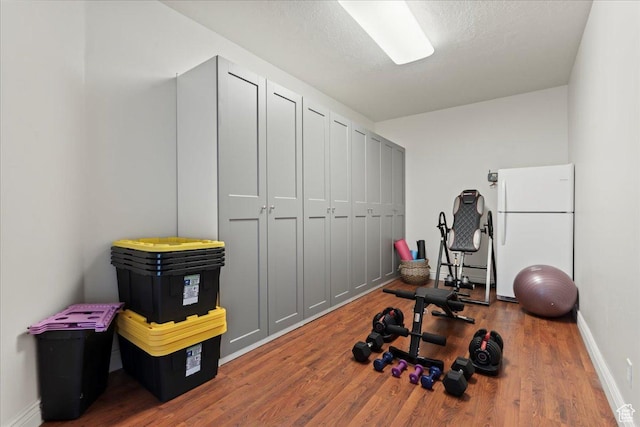 14771 S Brewster Dr, Draper, UT 84020 - workout area with wood finished floors, baseboards, and a baseboard heating unit