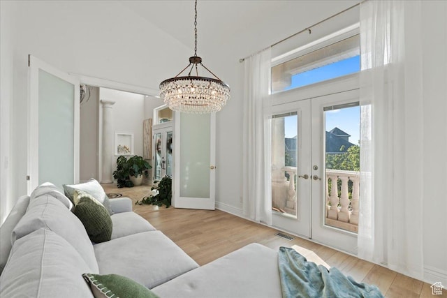 14771 S Brewster Dr, Draper, UT 84020 - living room with french doors, a chandelier, wood finished floors, baseboards, and a towering ceiling