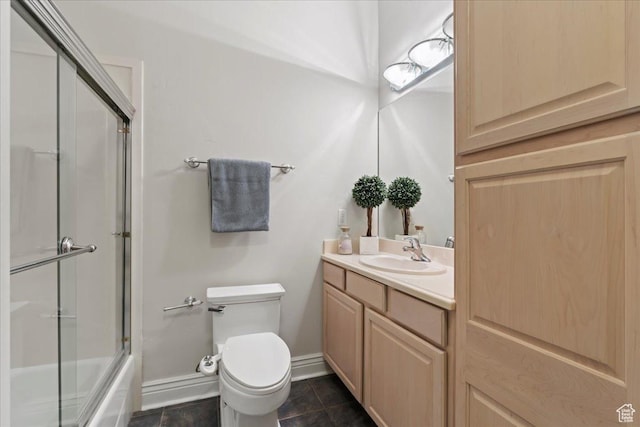 14771 S Brewster Dr, Draper, UT 84020 - bathroom featuring toilet, vanity, tile patterned flooring, baseboards, and shower / bath combination with glass door