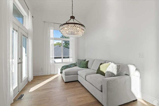 14771 S Brewster Dr, Draper, UT 84020 - living area featuring a chandelier, light wood-style floors, and baseboards