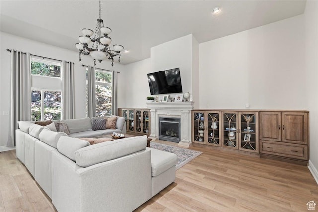 14771 S Brewster Dr, Draper, UT 84020 - living room with a chandelier, light wood-type flooring, a glass covered fireplace, and recessed lighting