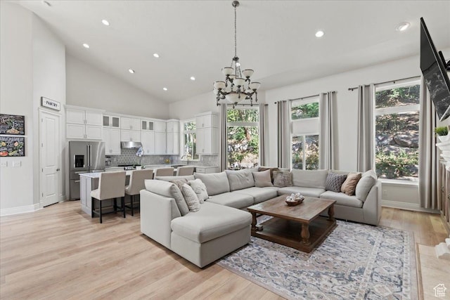 14771 S Brewster Dr, Draper, UT 84020 - living room with a chandelier, light wood-style floors, recessed lighting, high vaulted ceiling, and baseboards
