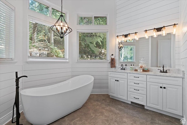 14771 S Brewster Dr, Draper, UT 84020 - full bath with a chandelier, wooden walls, double vanity, a freestanding tub, and a towering ceiling