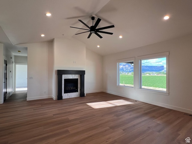 1234 N 4925 W, Plain City, UT 84404 - unfurnished living room featuring a premium fireplace, a ceiling fan, baseboards, wood finished floors, and lofted ceiling