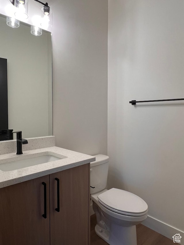 1234 N 4925 W, Plain City, UT 84404 - bathroom featuring toilet, vanity, baseboards, and wood finished floors