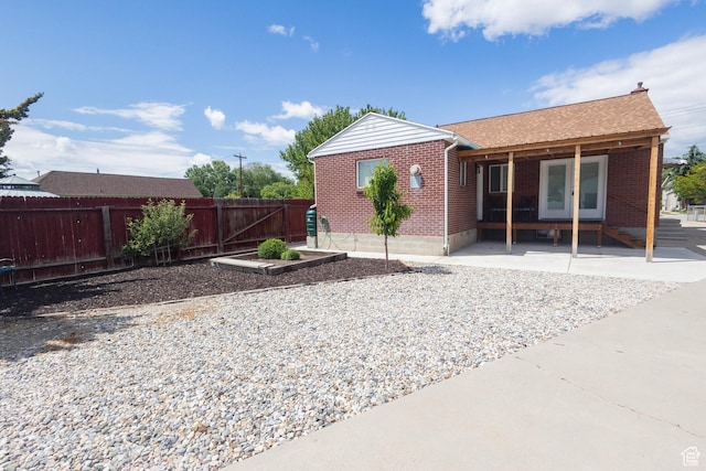 595 W Winchester St, Murray, UT 84123 - back of house with brick siding, a garden, and a shingled roof