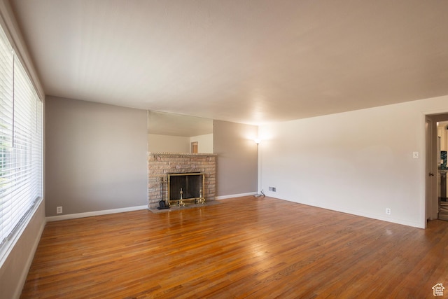 595 W Winchester St, Murray, UT 84123 - unfurnished living room featuring wood finished floors, baseboards, and a fireplace