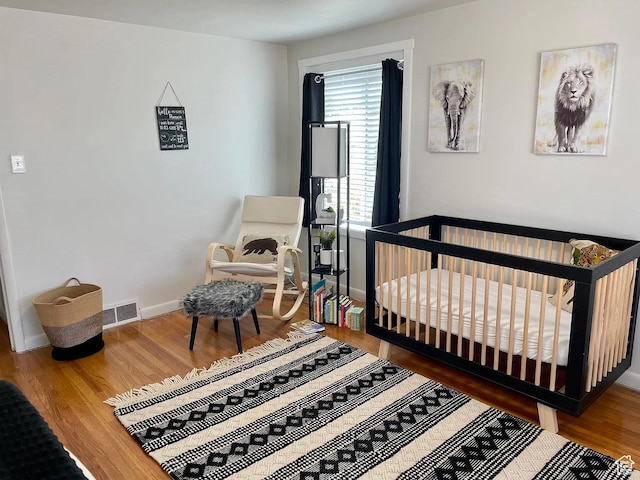 595 W Winchester St, Murray, UT 84123 - bedroom featuring wood finished floors, baseboards, and a nursery area