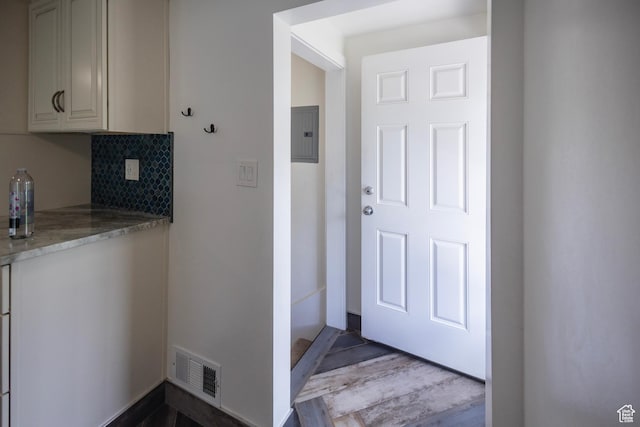 595 W Winchester St, Murray, UT 84123 - kitchen featuring electric panel, light stone counters, tasteful backsplash, and wood finished floors