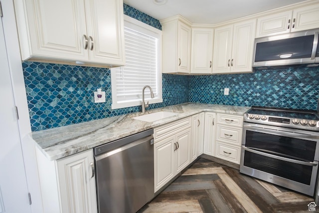 595 W Winchester St, Murray, UT 84123 - kitchen featuring stainless steel appliances, a sink, light stone countertops, and backsplash